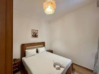 a bedroom with a white bed with a light at Appartement cosy et moderne familial in Marrakech