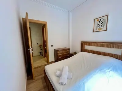 a bedroom with a bed with two towels on it at Appartement cosy et moderne familial in Marrakech