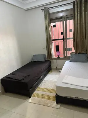 a bedroom with two beds and a window at New and nice apartment in Marrakech
