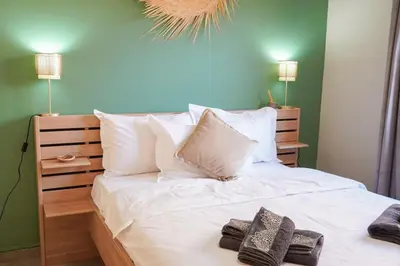a bedroom with a white bed with towels on it at Modern 2 bedroom apartment, one with terrace in Marrakech