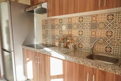 a kitchen with a sink and a refrigerator at Modern 2 bedroom apartment, one with terrace in Marrakech