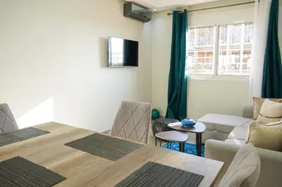 a living room with a table and a couch at Modern 2 bedroom apartment, one with terrace in Marrakech