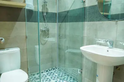 a bathroom with a shower and a toilet and a sink at Modern 2 bedroom apartment, one with terrace in Marrakech