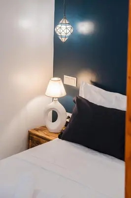 a bedroom with a bed and a lamp on a night stand at Riad Dar Z'r in Marrakech