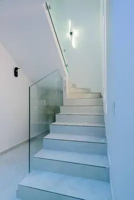 a staircase in a house with a glass wall at Duplex d'exception - 6 personnes - tout équipé in Marrakech