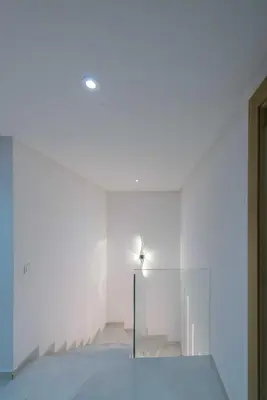 a white room with a glass wall and a light at Duplex d'exception - 6 personnes - tout équipé in Marrakech