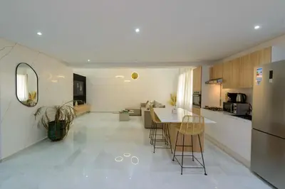 a kitchen with a table and chairs in a room at Duplex d'exception - 6 personnes - tout équipé in Marrakech