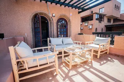 a patio with a table and chairs on a building at Palmeraie Tradition and Modernity in Marrakech
