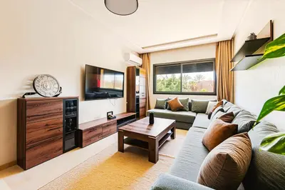 a living room with a couch and a tv at Rent Appartment In Marrakesh - Morocco - Semlalia in Marrakech