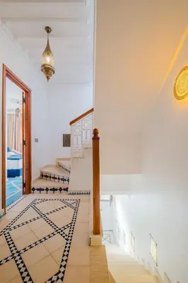 a staircase in a house with a tile floor at Riad Marrakech Dar Tivawin 3 rooms With Pool Private Riad in Marrakech