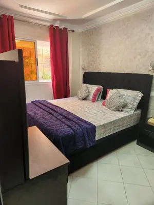 a bedroom with a bed with purple sheets and pillows at 2 bedroom apartment, living room, kitchen in Marrakech in Marrakech