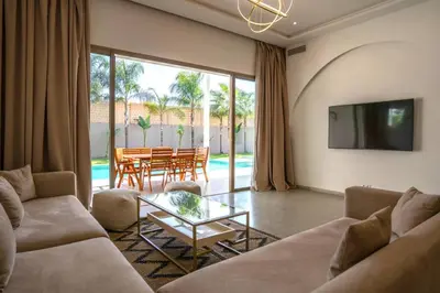 a living room with a couch and a table at Villa Seyana 2 Zero vis a vis, Piscine Chauffee in Marrakech