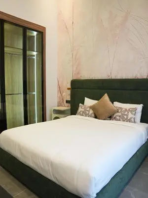 a bedroom with a large bed with white sheets and pillows at Villa Crystale - Marrakech in Marrakech
