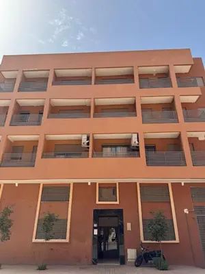 a large orange building with a door in front of it at Superbe Appart 3 pièces Moderne, Confort avec vue panoramique sur Marrakech plein centre à 7 min a pied de Gueliz in Marrakech