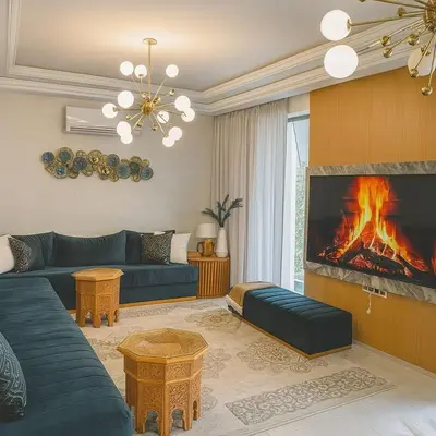 a living room with a blue couch and a fireplace at cozy villa 3 Rooms pool wifi -Only Family in Marrakech
