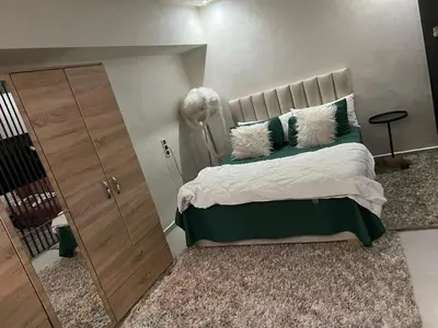 a bedroom with a large bed with green and white pillows at cozy villa 3 Rooms pool wifi -Only Family in Marrakech