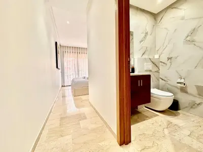 a bathroom with a toilet and a sink at Modern and Central Apartment with Terrace and Free Parking in Marrakech