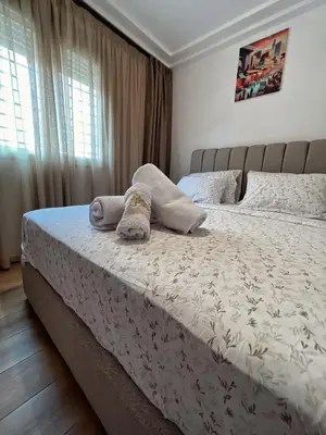 a bedroom with a bed with two towels on it at Cozy & Elegant apartment Marrakech in Marrakech