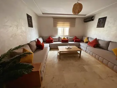 a living room with a couch and a table at Cozy & Elegant apartment Marrakech in Marrakech