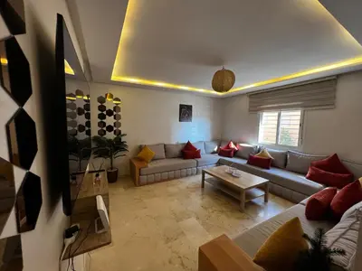 a living room with a couch and a table at Cozy & Elegant apartment Marrakech in Marrakech