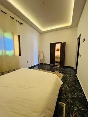 a bedroom with a large white bed in a room at Excellente Villa A Proximité De Marrakech in El Aïn
