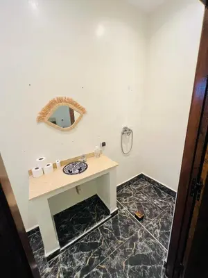 a bathroom with a sink and a mirror at Excellente Villa A Proximité De Marrakech in El Aïn