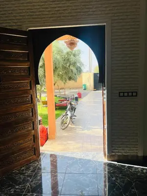 an open door to a building with a motorcycle in the background at Excellente Villa A Proximité De Marrakech in El Aïn