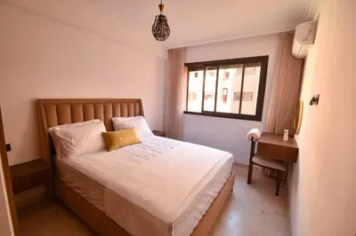 a small bedroom with a bed and a window at Superbe T3 neuf - Proche centre - Piscines et Clim - Marrakeck in Marrakech