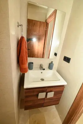 a bathroom with a sink and a mirror at Superbe T3 neuf - Proche centre - Piscines et Clim - Marrakeck in Marrakech