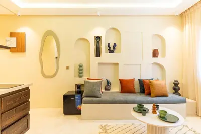 a living room with a couch and a table at Cosy appartement avec jacuzzi in Marrakech
