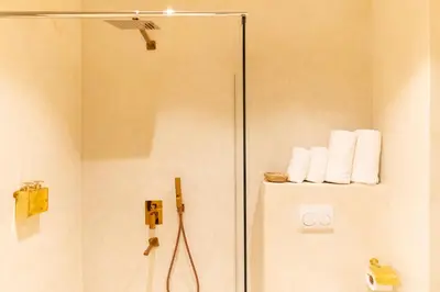 a bathroom with a shower with towels on a wall at Cosy appartement avec jacuzzi in Marrakech