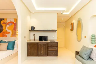 a living room with a couch and a table at Cosy appartement avec jacuzzi in Marrakech