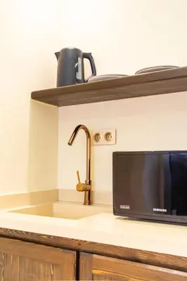 a kitchen counter with a sink and a microwave at Cosy appartement avec jacuzzi in Marrakech