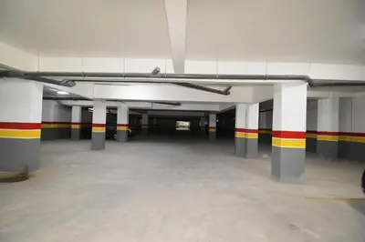 an empty parking garage with colorful stripes on the walls at Superbe T2 neuf - Proche centre - Piscines et Balcon - Marrakech in Marrakech