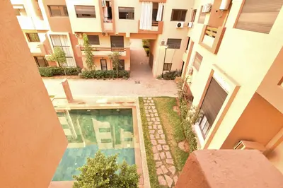 an aerial view of a building with a swimming pool at Superbe T2 neuf - Proche centre - Piscines et Balcon - Marrakech in Marrakech