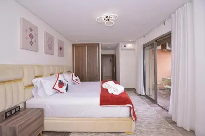a bedroom with a bed with red and white towels on it at Appart Essalam in Marrakech