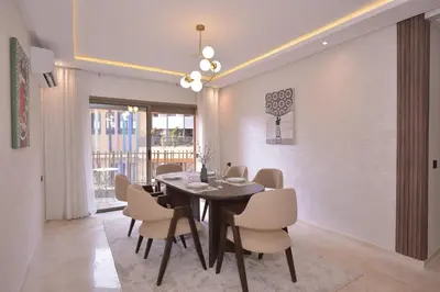 a dining room with a table and chairs at Appart Essalam in Marrakech