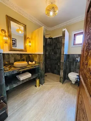 a bathroom with a sink and a toilet and a mirror at Riad LALA ASMAA Riad privé in Marrakech