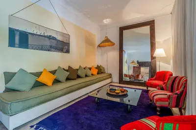 a living room with a couch and a table at Riad Litote in the heart of the Kasbah in Marrakech