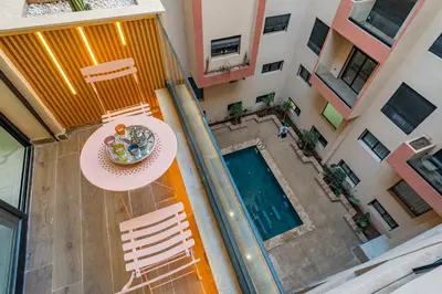 an overhead view of a balcony with a table and chairs at Modern Hivernage Studio Retreat Pool & central access in Marrakech