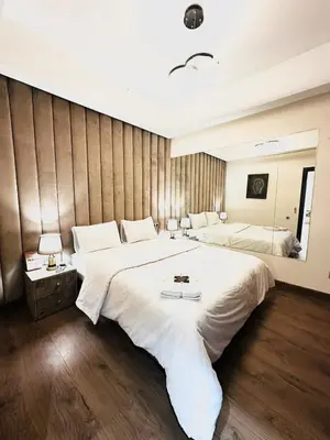 a large bedroom with two beds and a mirror at Chic Stay in Gueliz 2, Parking sur place, Netflix in Marrakech