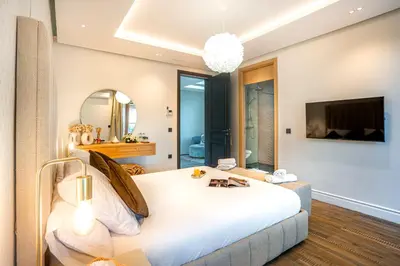 a bedroom with a large white bed and a mirror at Villa Syria Marrakech Amelkis 3 in Marrakech