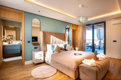 a bedroom with a large bed and a bathroom at Villa Syria Marrakech Amelkis 3 in Marrakech