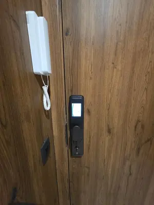 a cell phone is hanging on a wooden door at Appartement Gueliz Haut de gamme Residence 5 piscines in Marrakech