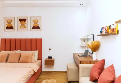 a bedroom with a bed and a couch at Menara Garden Cosy Appartement Hivernage Marrakech in Marrakech