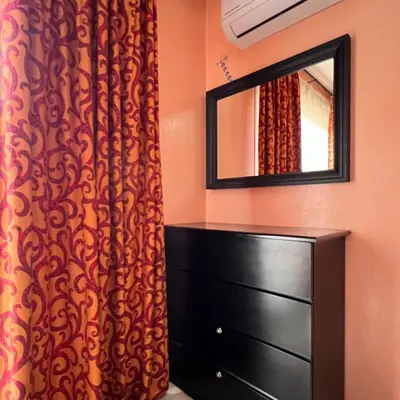 a bedroom with a dresser and a mirror at Marrakech Family Stay City Center in Marrakech