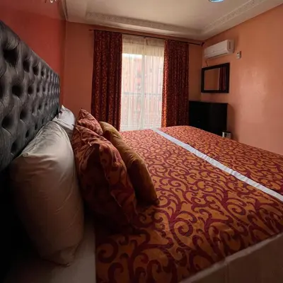 a bedroom with a large bed and a window at Marrakech Family Stay City Center in Marrakech