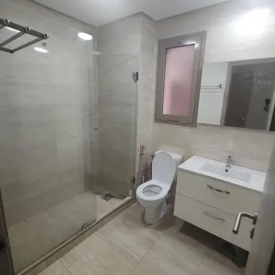 a bathroom with a toilet and a shower and a sink at T3 Jade Prestigia Pool in Marrakech