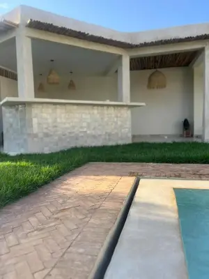 a house with a swimming pool in front of it at Dar Mayleya in Marrakech