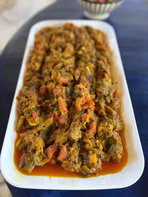 a dish of food with meat and sauce on a table at Dar Mayleya in Marrakech